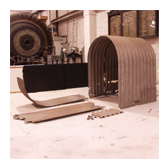 The parts of an Anderson shelter displayed in a warehouse.