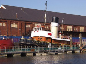 Photograph of the Canning tug moored on a pontoon.