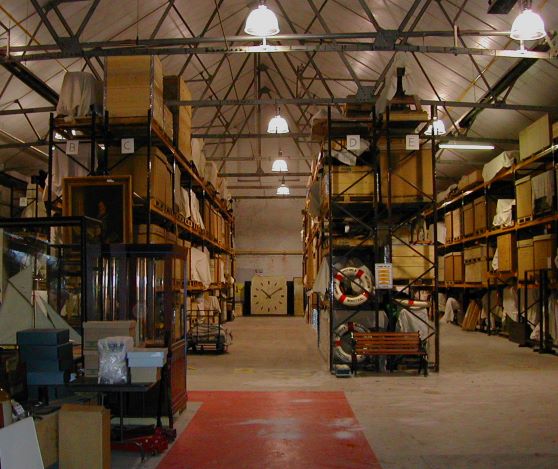 Photograph of the interior of Swansea museum's Collections Centre showing high racking and crates.